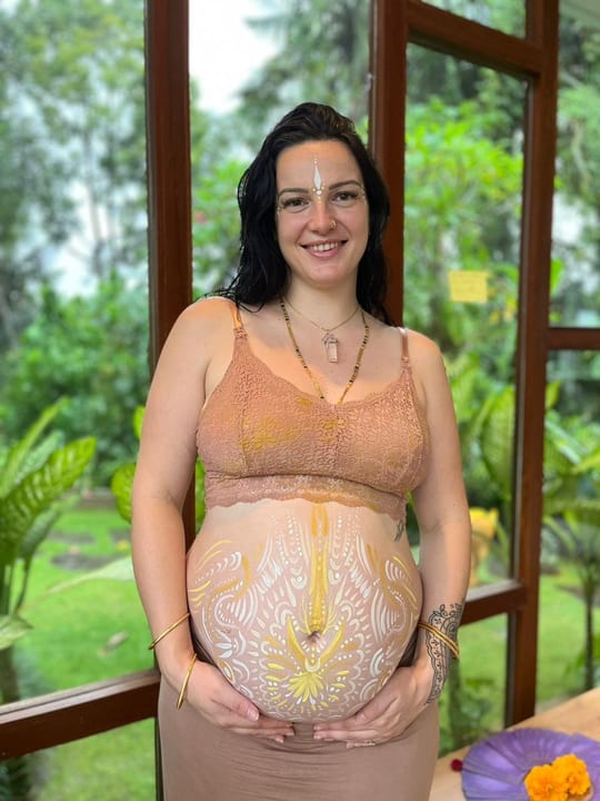 Mel, founder of Above Our Love, pregnant with ceremonial belly painting